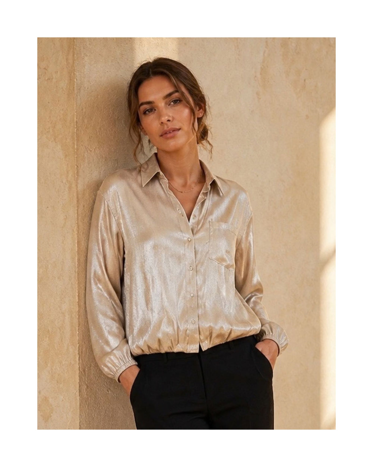 Soepelvallende blouse met knopen, borstzakje en subtiele glans, verkrijgbaar bij Marijke Mode.